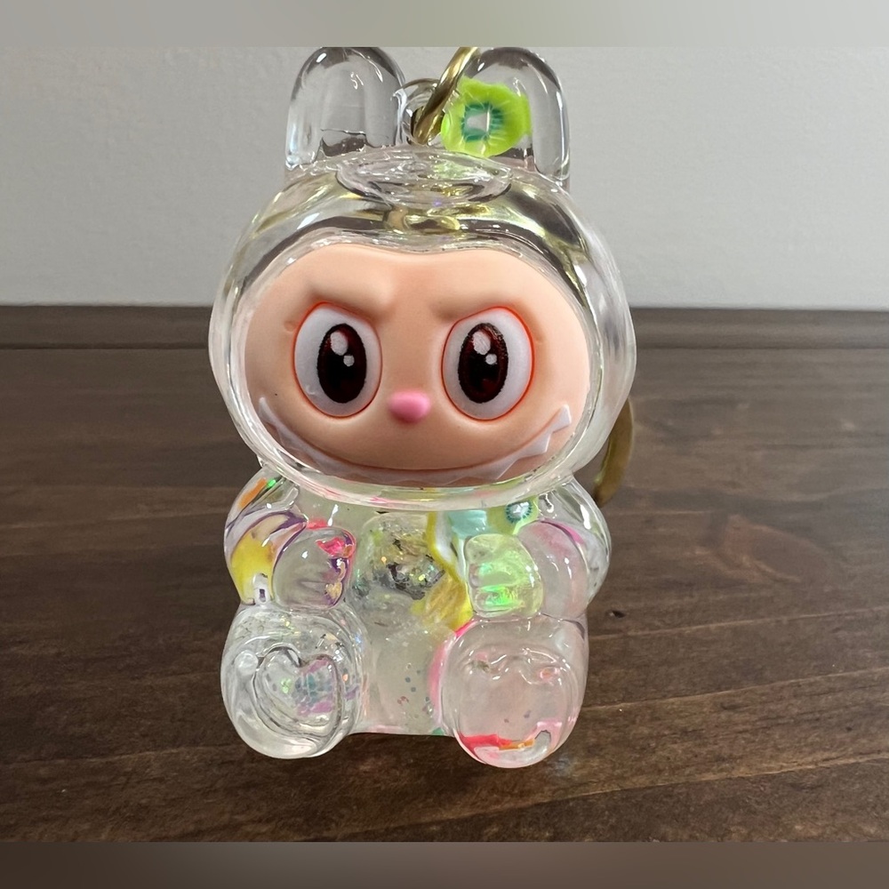 Pop Mart Labubu-inspired quicksand keychain shaker with a transparent bunny-shap